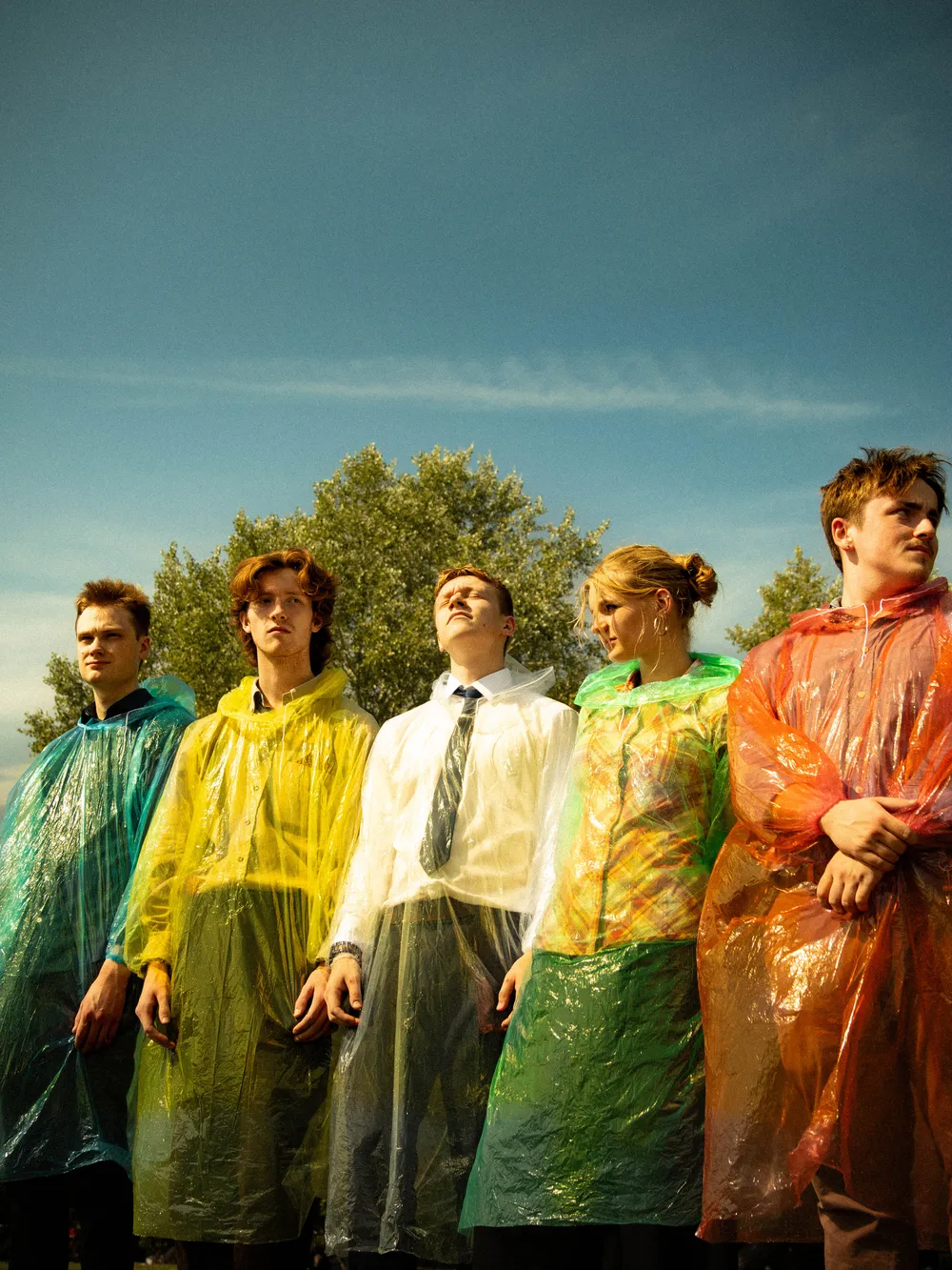 Tiebreak, five band members in coloured rain ponchos